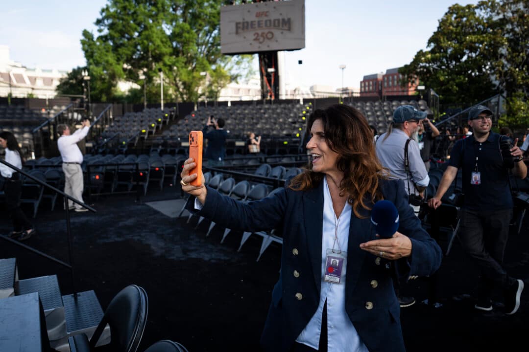 A member of the press takes a video as she walks through the UFC media preview at the White House on June 11, 2026. (Madalina Kilroy/The Epoch Times)