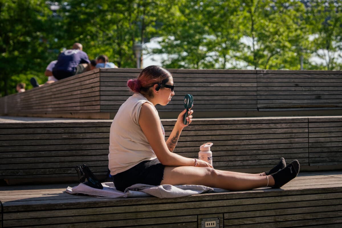 A person uses a fan during a heat advisory in the Brooklyn borough of New York City, May 19, 2026. (AP Photo/Adam Gray, File)