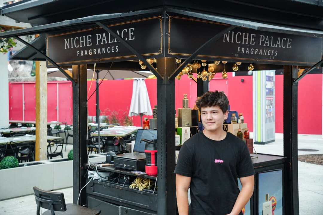 Alex Rodriguez, 19, who witnessed a “teen takeover” while at work, describes the chaotic scene from the fragrance stand where he works at Icon Park in Orlando on May 9, 2026. About 1,000 teenagers descended on the entertainment complex on April 25. (Troy Myers/The Epoch Times)