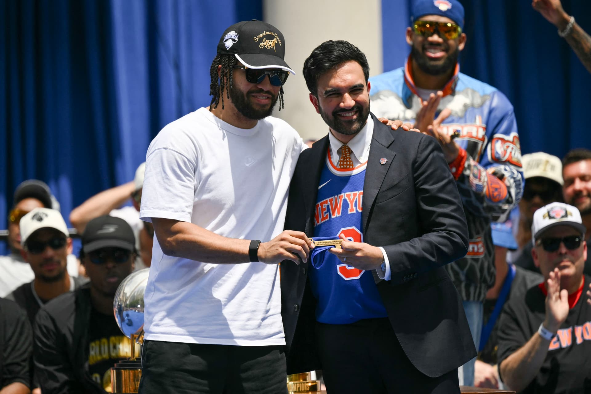 New York Mayor Zohran Mamdani (R) gives the Knicks' Jalen Brunson the keys to the city during a championship celebration at City Hall Plaza on June 18, 2026. (Angela Weiss/AFP)