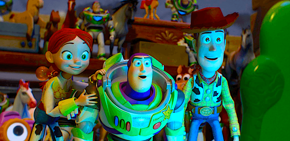 (L–R) Jessie (voiced by Joan Cusack), Buzz Lightyear (voiced by Tim Allen), and Woody (voiced by Tom Hanks) look at Bonnie's tablet in "Toy Story 5." (Walt Disney Studios Motion Pictures)