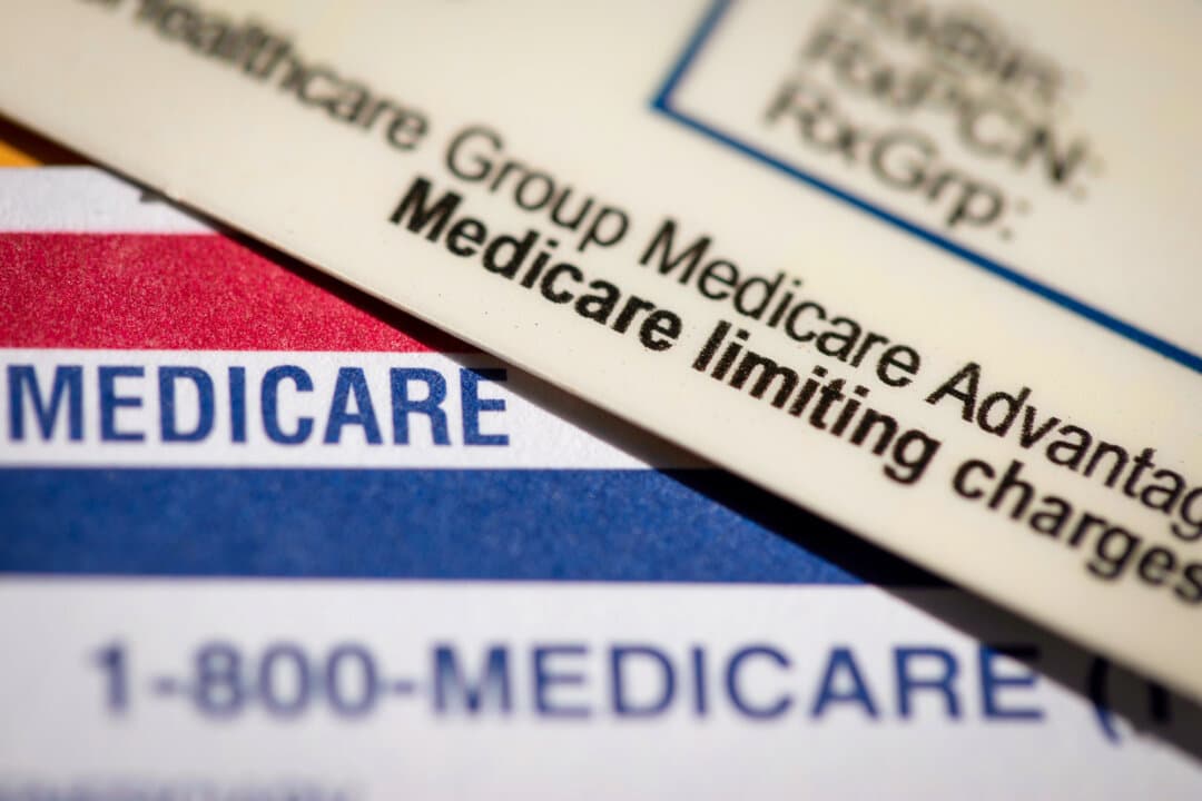 A Medicare Advantage PPO card sits on top of a Medicare card, in this file photo. The Trump administration has been aggressive in Medicare and Medicaid fraud enforcement. (AP/Jenny Kane)