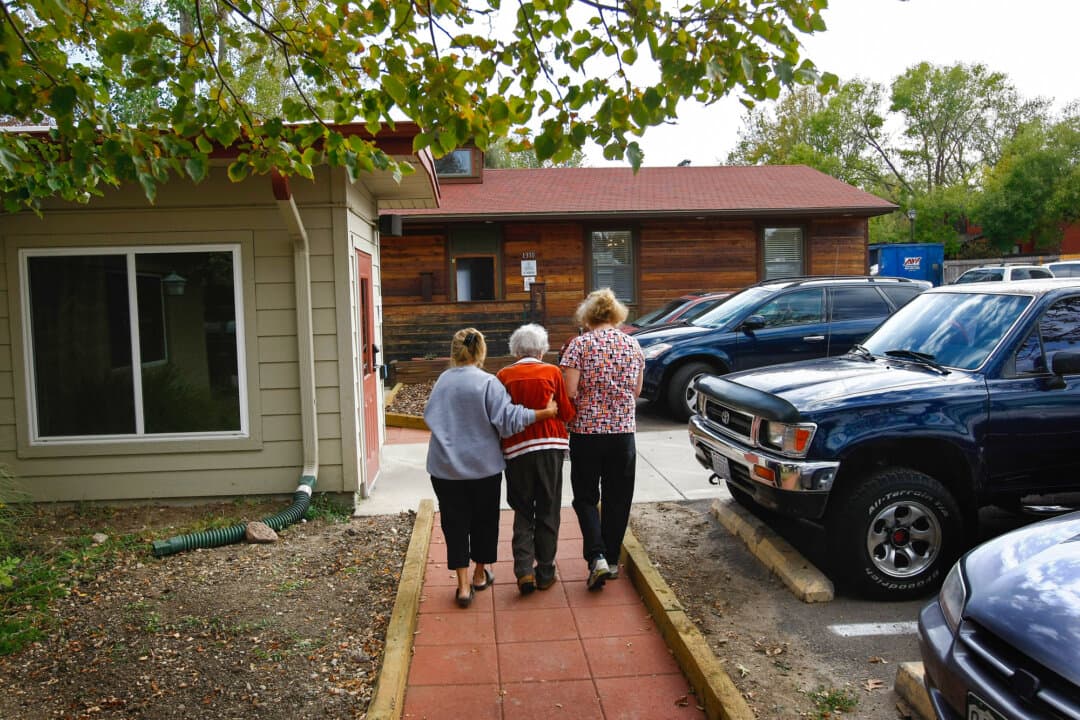 Volunteers assist a terminally ill patient at a hospice in Denver on Oct. 7, 2009. The administration’s efforts to clamp down on hospice fraud have been praised by some patient advocates, including the American Association of Retired Persons. (John Moore/Getty Images)