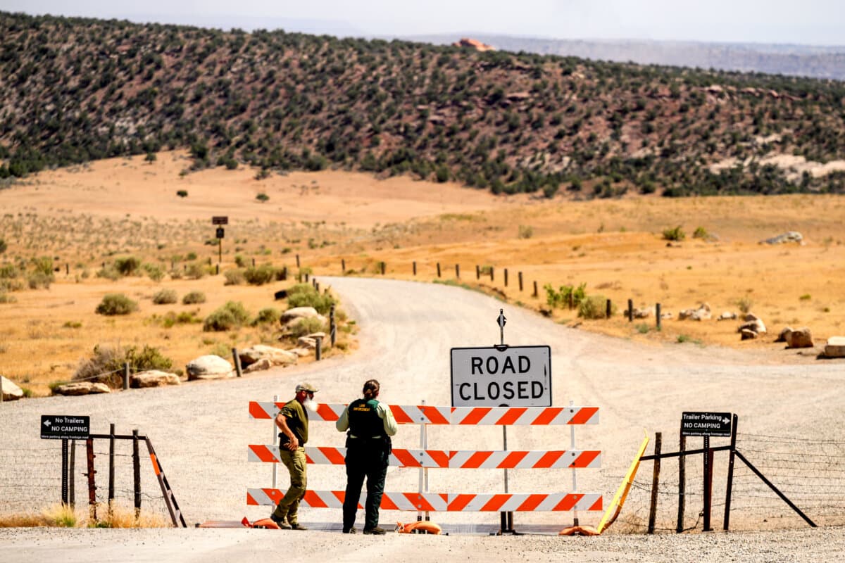 Law enforcement officers staff a roadblock as the Snyder Fire burns near Mack, Colo., on June 28, 2026. (AP Photo/Noah Berger)