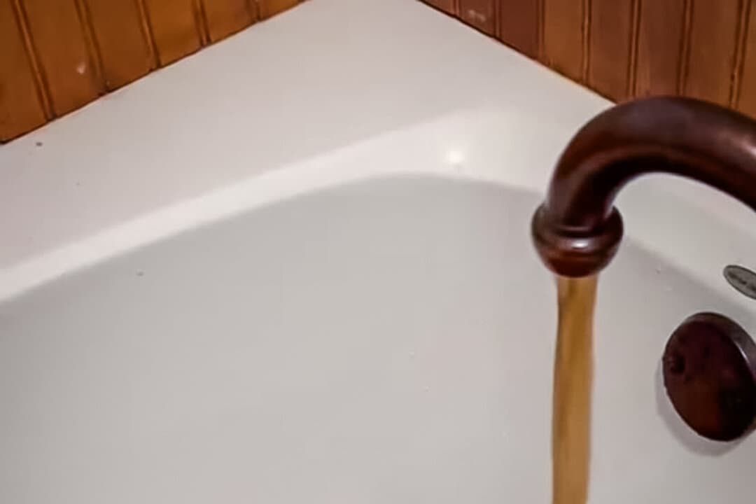 Discolored water runs in a tub in Trinidad, Texas, in a photo provided by attorneys for Jennifer Combs, in this file photo. Combs is suing the city after the police arrested her on felony charges after she questioned the city’s water quality. (Courtesy of CJ Grisham) 