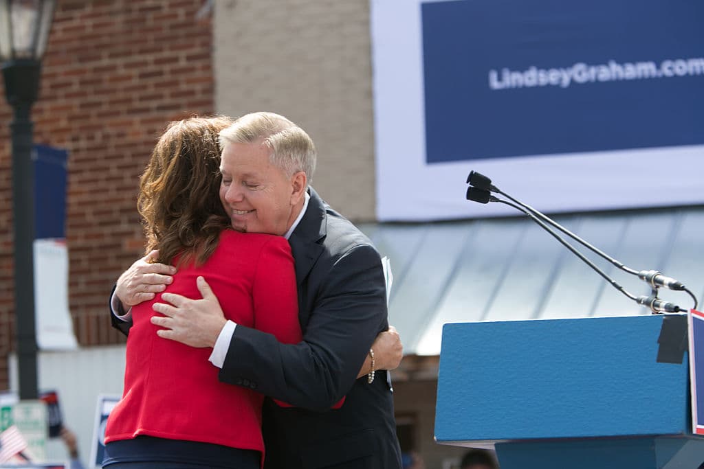U.S. Sen. Lindsey Graham (R-SC) hugs his sister Darline Graham Nordone on stage as he announces his candidacy for United States President during an outdoor event for supporters, in Central, S.C., on June 1, 2015. Graham is the ninth Republican to join the race for president in 2016. (Jessica McGowan/Getty Images)