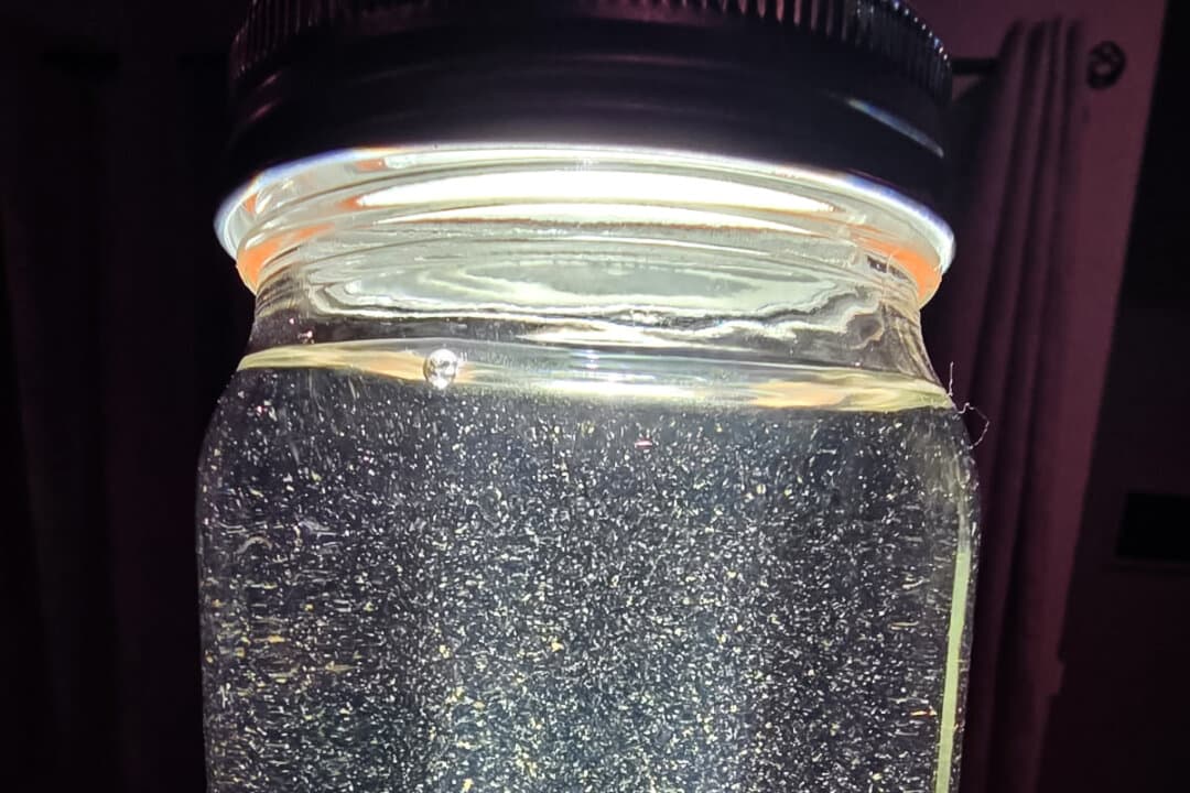 A flashlight illuminates a sample of Trinidad water in a photo provided by attorneys for Jennifer Combs, in this file photo. (Courtesy of CJ Grisham)