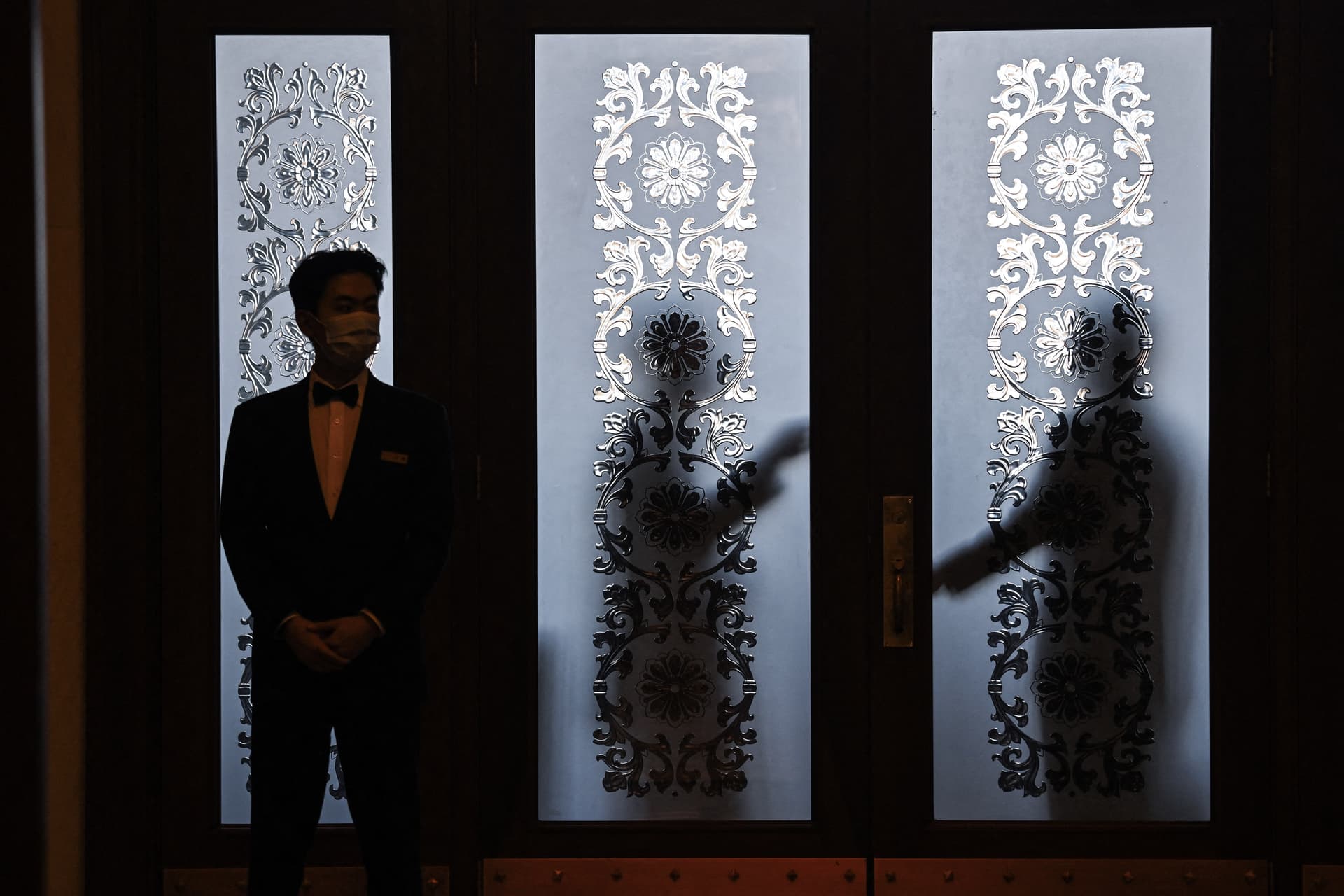 Security guards stand behind a glass door at the Great Hall of the People in Beijing on March 6, 2024. (Greg Baker/AFP via Getty Images)