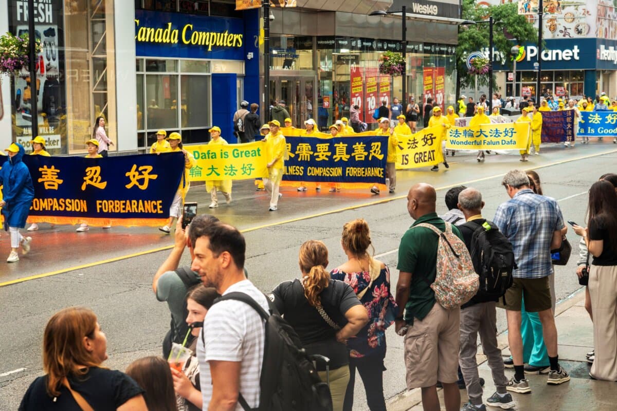 Falun Gong practitioners hold a parade in downtown Toronto to mark 27 years of the CCP’s persecution of the peaceful meditation discipline, on July 18, 2026. (Evan Ning/The Epoch Times)