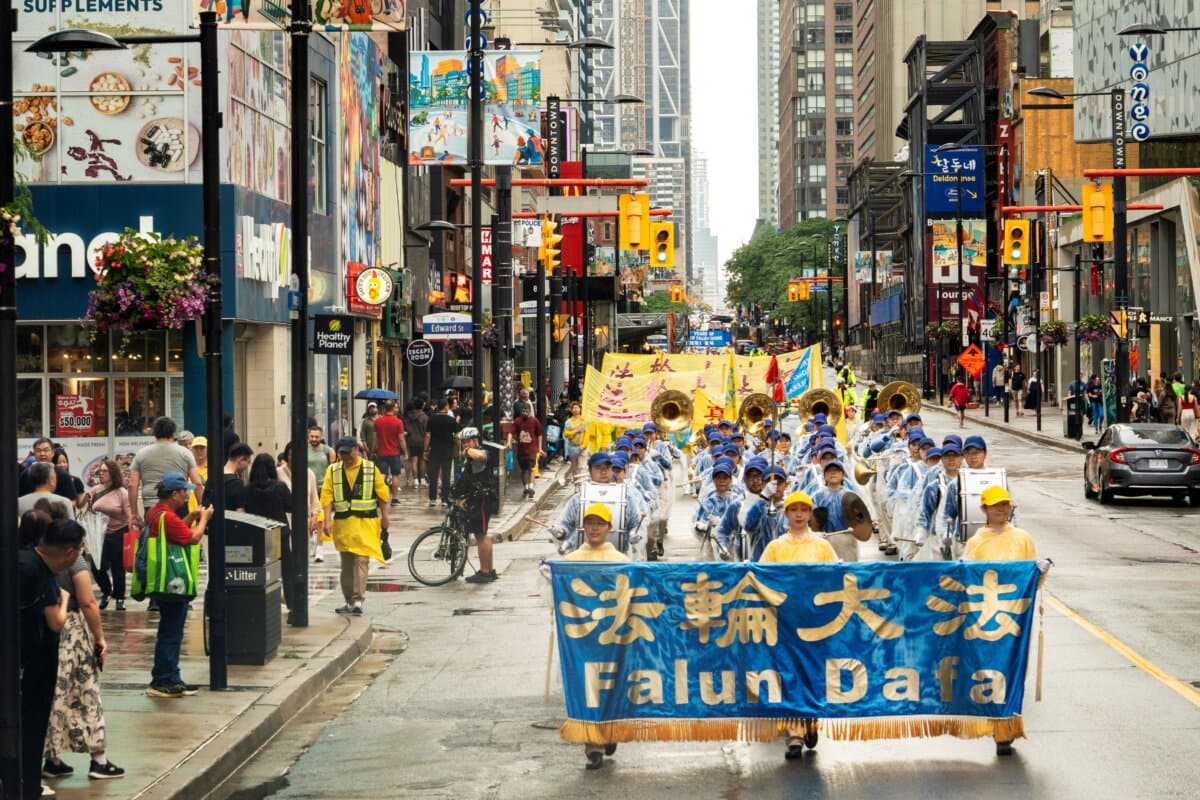 Falun Gong practitioners hold a parade in downtown Toronto to mark 27 years of CCP’s persecution of the peaceful meditation discipline, on July 18, 2026. (Evan Ning/The Epoch Times)