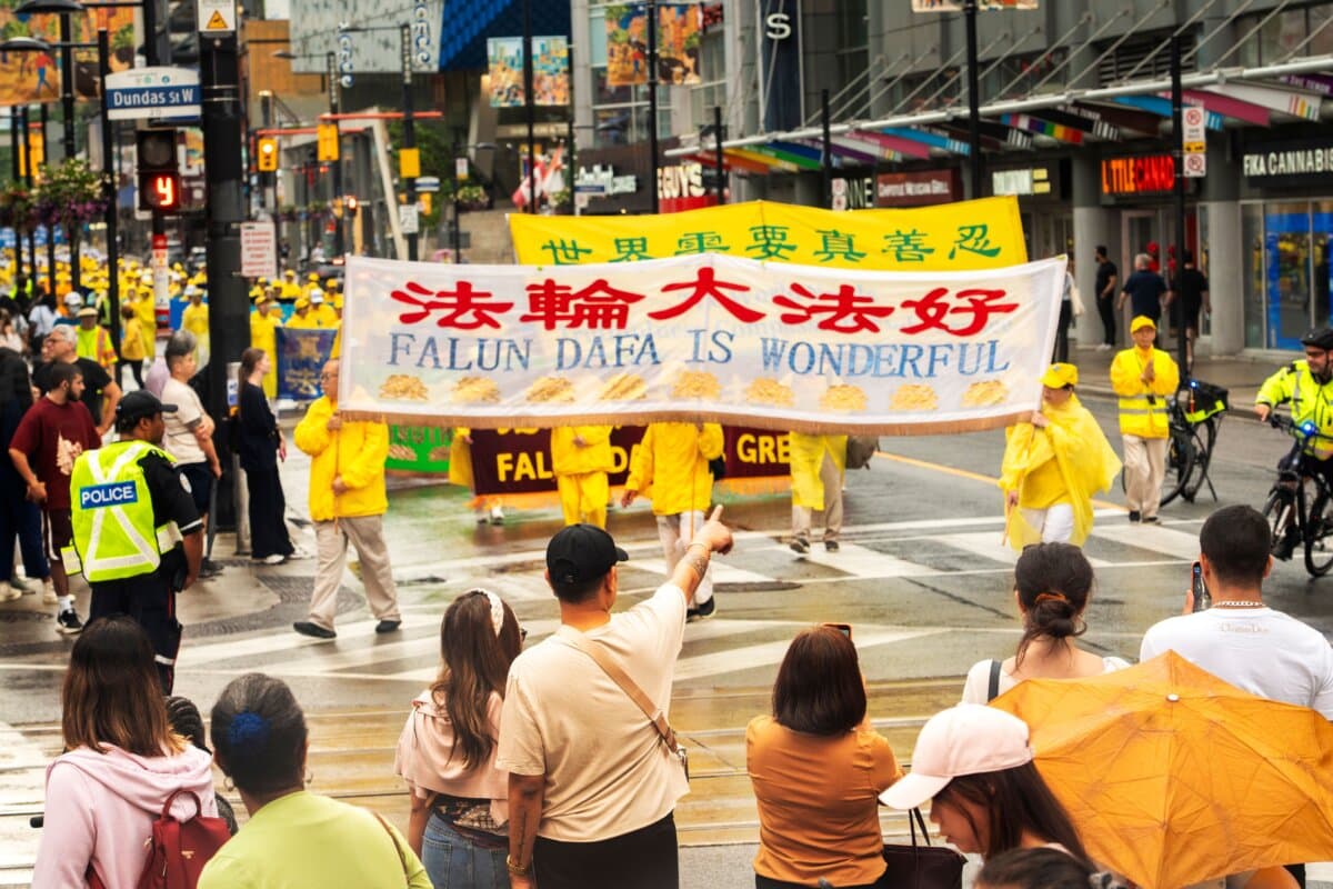 Falun Gong practitioners hold a parade in downtown Toronto to mark 27 years of CCP’s persecution of the peaceful meditation discipline, on July 18, 2026. (Evan Ning/The Epoch Times)