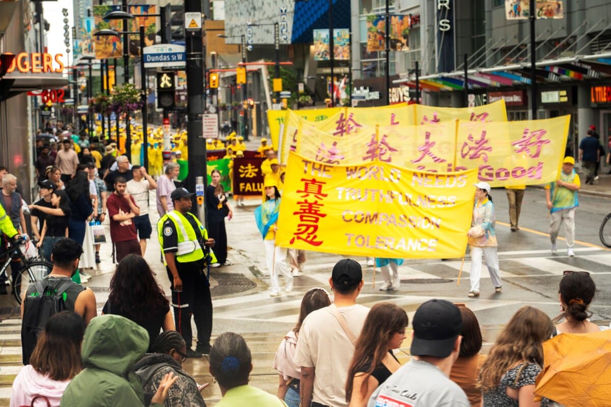 Falun Gong practitioners hold a parade in downtown Toronto to mark 27 years of CCP’s persecution of the peaceful meditation discipline, on July 18, 2026. (Evan Ning/The Epoch Times)