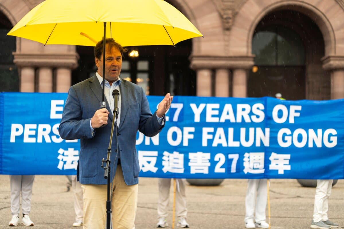 Dean Baxendale, CEO of Optimum Publishing International and the China Democracy Fund, speaks at a rally to mark 27 years of CCP's persecution of Falun Gong, at Queen's Park, Toronto, on July 18, 2026. (Evan Ning/The Epoch Times)