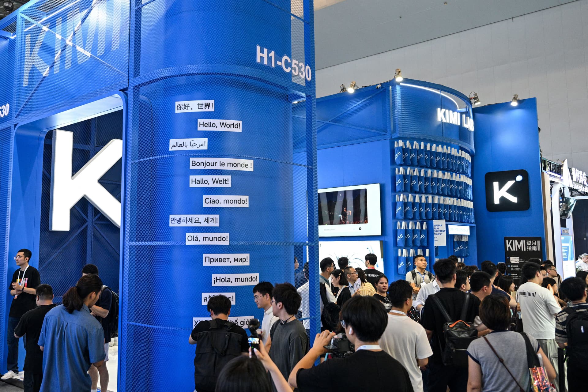 People visit the Moonshot AI stand, featuring the Kimi K3 model, during the World Artificial Intelligence Conference in Shanghai on July 18, 2026. (Hector Retamal/AFP via Getty Images)