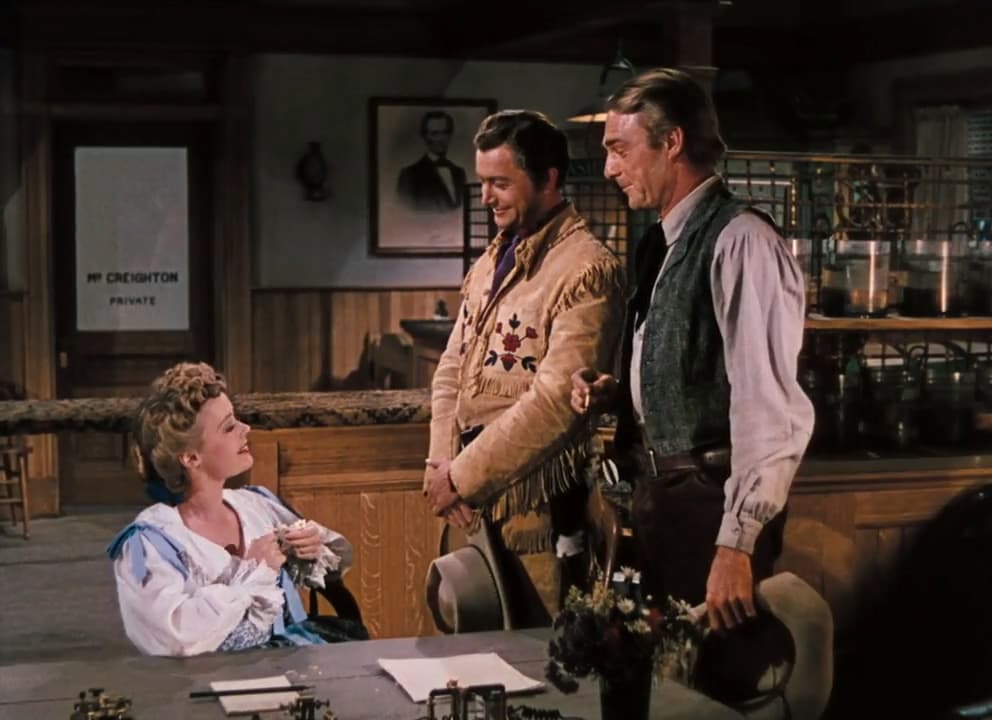 (L–R) Sue Creighton (Virginia Gilmore) entertains suitors Richard Blake (Robert Young) and Vance Shaw (Randolph Scott), in “Western Union.” (20th Century Fox)