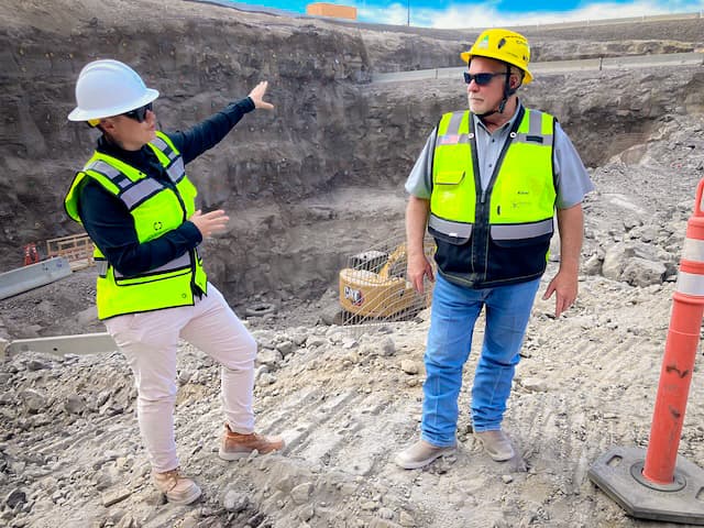Atlas Engineering project manager Hillary Hack (L) and Kiewit Nuclear construction site manager Marvin Robb meet on the Idaho National Laboratory site, west of Idaho Falls, Idaho, in late June 2026. Their challenges include the 75-foot deep excavation they’ve dug since February, which will house Oklo’s Aurora Powerhouse Project. (John Haughey/The Epoch Times)