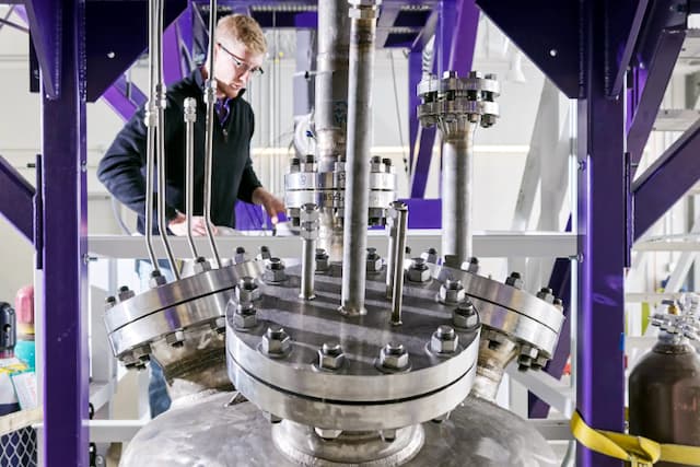 A technician monitors Natura Resources’ MSR-1 molten salt research reactor in Lockhart, Texas in 2024. The reactor is the first liquid-fueled advanced reactor ever licensed and first university research reactor approved in more than 30 years. (Courtesy of Natura Resources) 