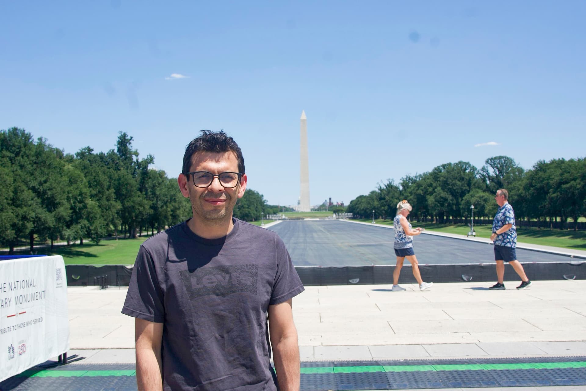 Andres Mancpecce, from Colombia, stands near thousands of Falun Gong practitioners who were lining up for a parade at the Lincoln Memorial in Washington, on July 23, 2026. (Karina Li for The Epoch Times)