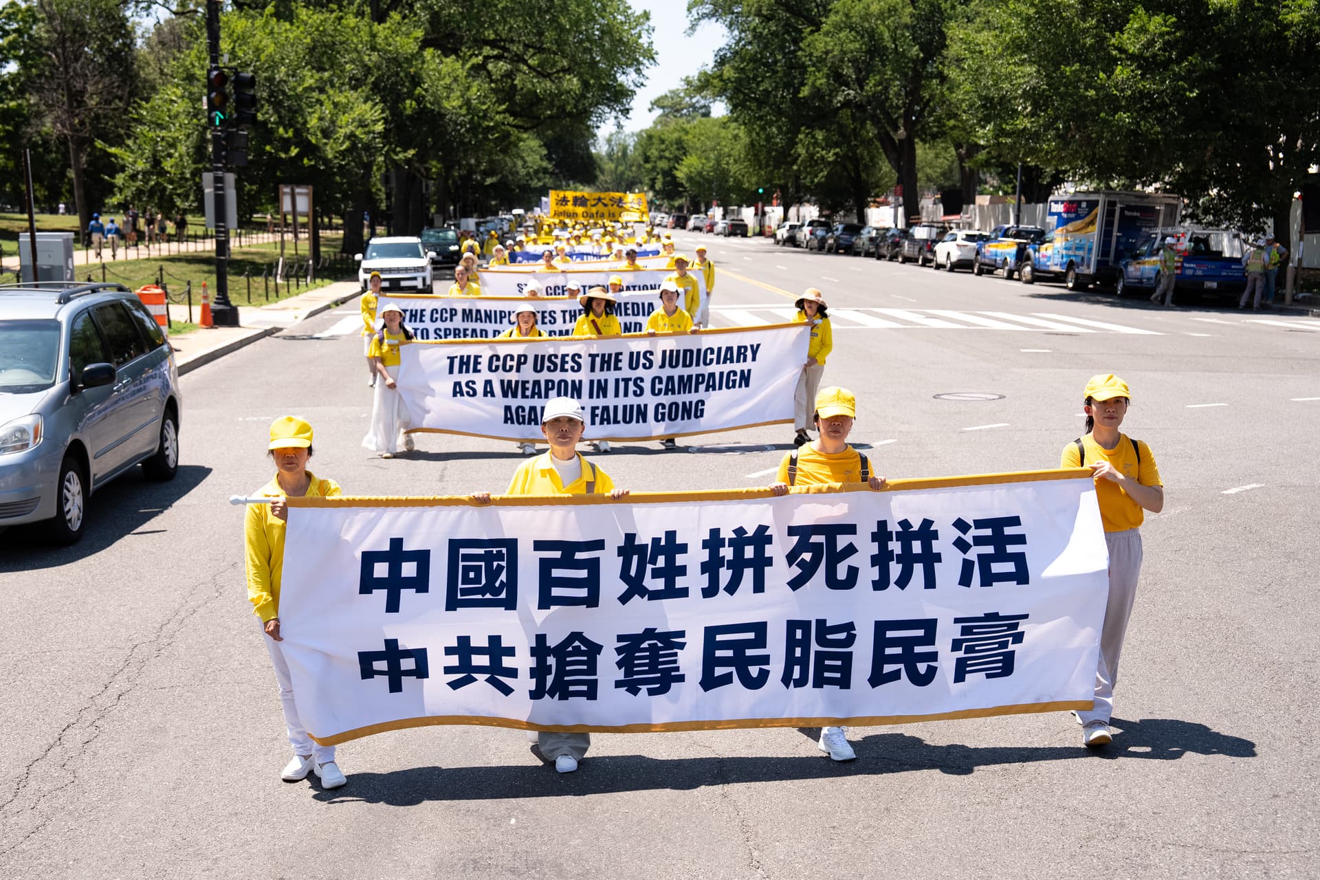 Falun Dafa practitioners take part in a march calling for the end of the Chinese Communist Party’s 27 years of persecution of Falun Gong in China, in Washington on July 23, 2026. (Larry Dye/The Epoch Times)
