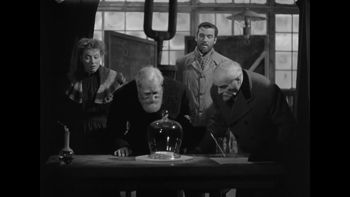 (L–R) Marie Curie (Greer Garson), Jean Perot (Albert Bassermann), Pierre Curie (Walter Pidgeon), and Dr. Becquerel (Reginald Owen), in “Madame Curie.” (Metro-Goldwyn-Mayer)