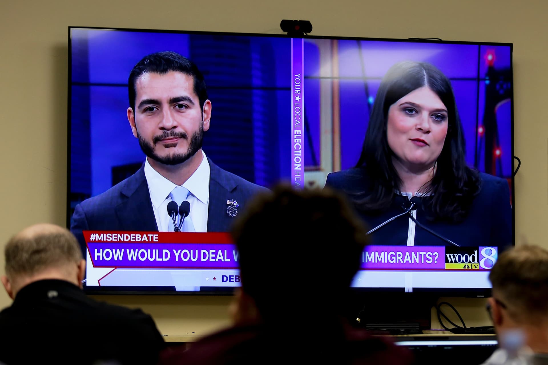 U.S. Senate candidates for Michigan, Abdul El-Sayed (L) and Rep. Haley Stevens (D-Mich.), are seen on television during a debate inside the spin room at WoodTV studios in Grand Rapids, Mich., on July 7, 2026. (AP Photo/Kristen Norman)