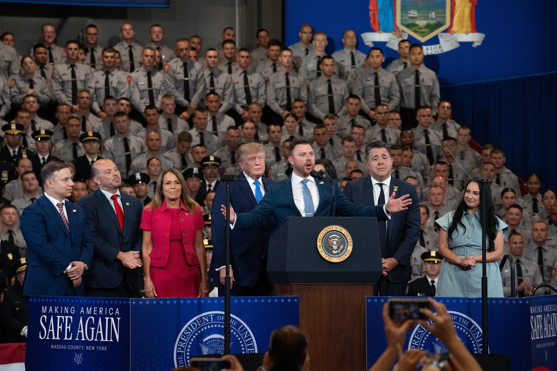 Candidates endorsed by President Trump join him on stage at the Nassau County Police Academy David S. Mack Center for Training and Intelligence in Garden City, N.Y., on Aug. 14, 2026. (Samira Bouaou/The Epoch Times)