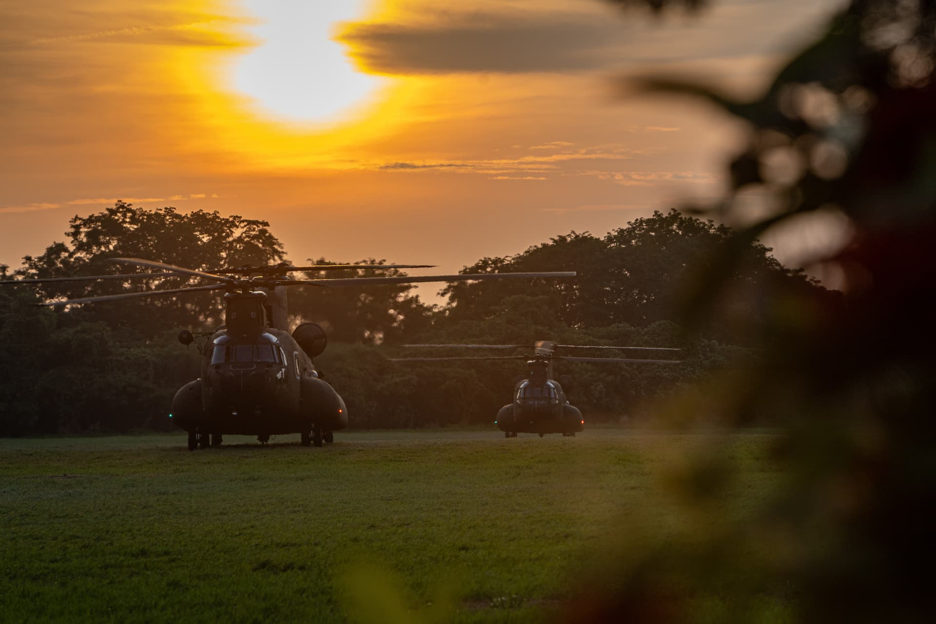 Taiwan Army CH-47SD Chinook transport helicopters sit on the grass field at sunset during a tactical exercise in Tainan, Taiwan, on Aug. 12, 2026 . (Cheng Chia Huang/Getty Images)