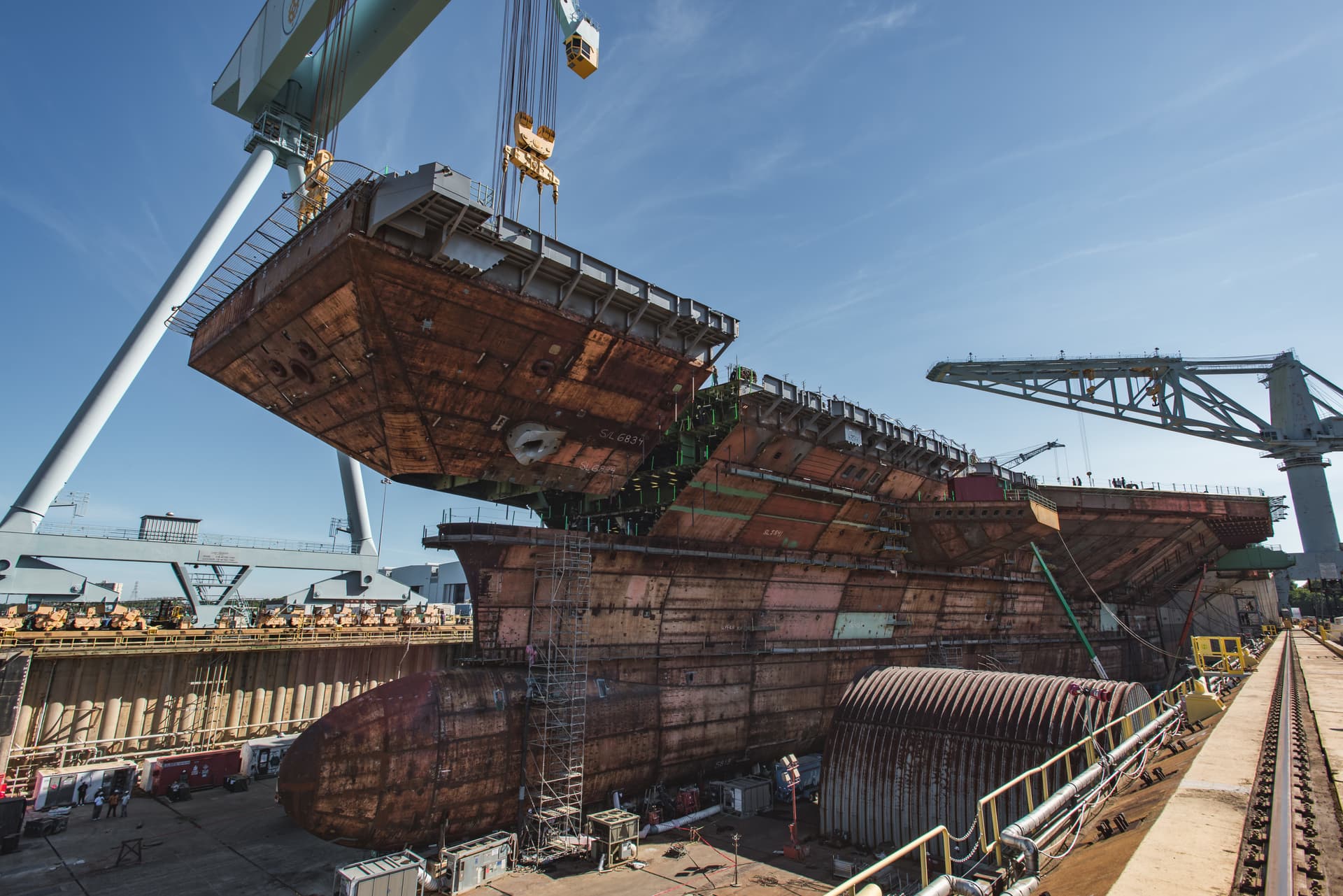 The upper bow unit of the future aircraft carrier USS John F. Kennedy is fitted to the primary structure of the ship, at Huntington Ingalls Industries Newport News Shipbuilding, in Newport News, Virginia, on July 10, 2019. (U.S. Navy/Courtesy of Huntington Ingalls Industries by Matt Hildreth)