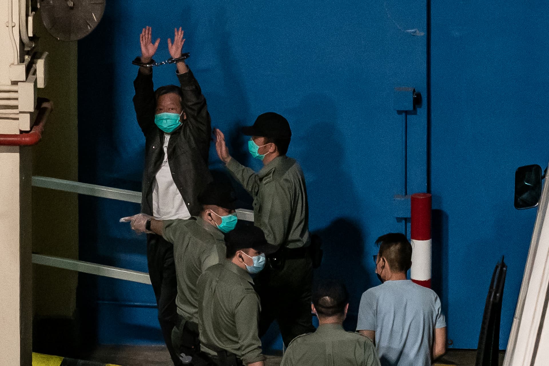 Pro-democracy activist and former lawmaker Lee Cheuk-yan gestures as he arrives at Lai Chi Kok Reception Center in Hong Kong on April 16, 2021. (Anthony Kwan/Getty Images)
