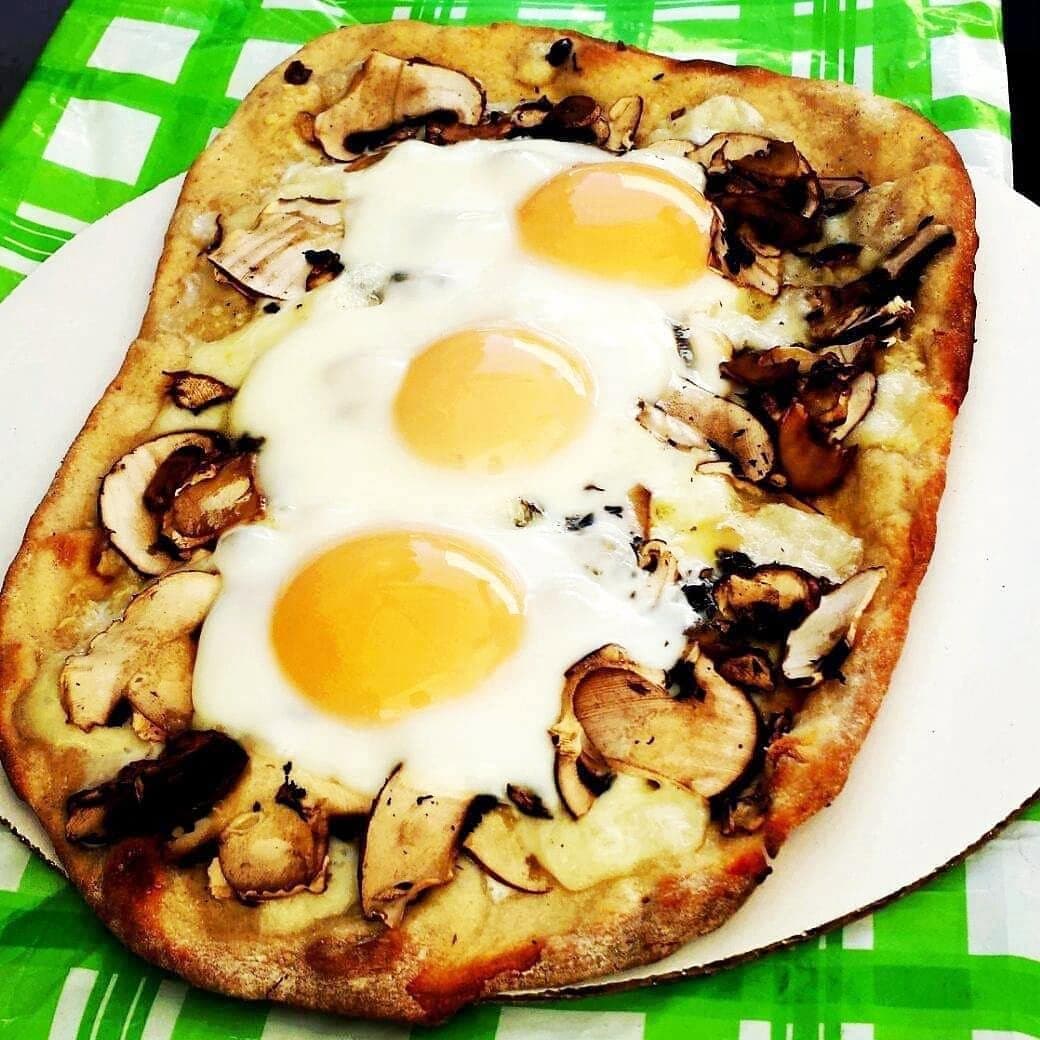 A pizza made at MEHKO home restaurant Queen of Crusts, topped with eggs from owner Kellie Joe’s chickens. (Courtesy of Kellie Joe)