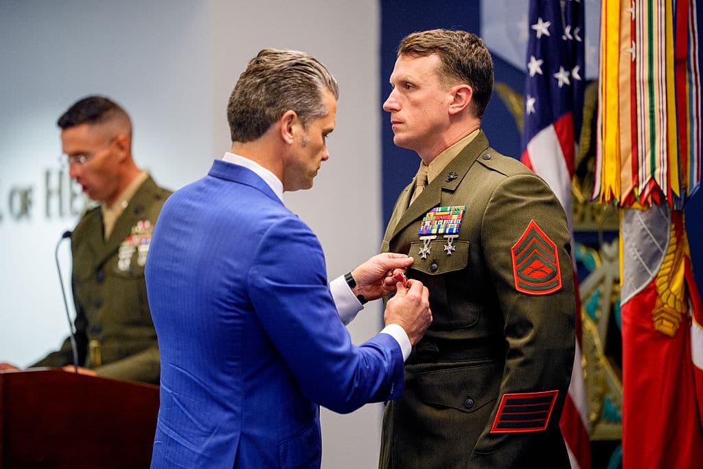 War Secretary Pete Hegseth (L) pins a medal on Marine GySgt. Jonathan Eby (R) during an event to honor Marines who were serving during the 2021 Abbey Gate bombing, at the Pentagon in Arlington, Va., on Aug. 26, 2026. (Andrew Harnik/Getty Images)