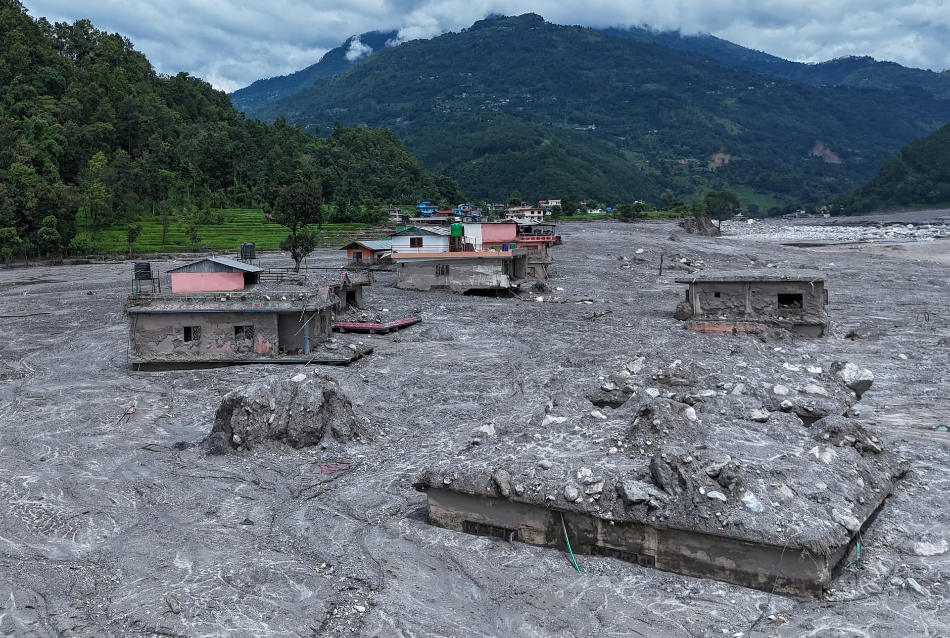 An aerial view of houses surrounded by mud, rocks and debris following flash floods in Betravati village, Rasuwa, Nepal, on Sept. 3, 2026. (Ritesh Shukla/Getty Images)