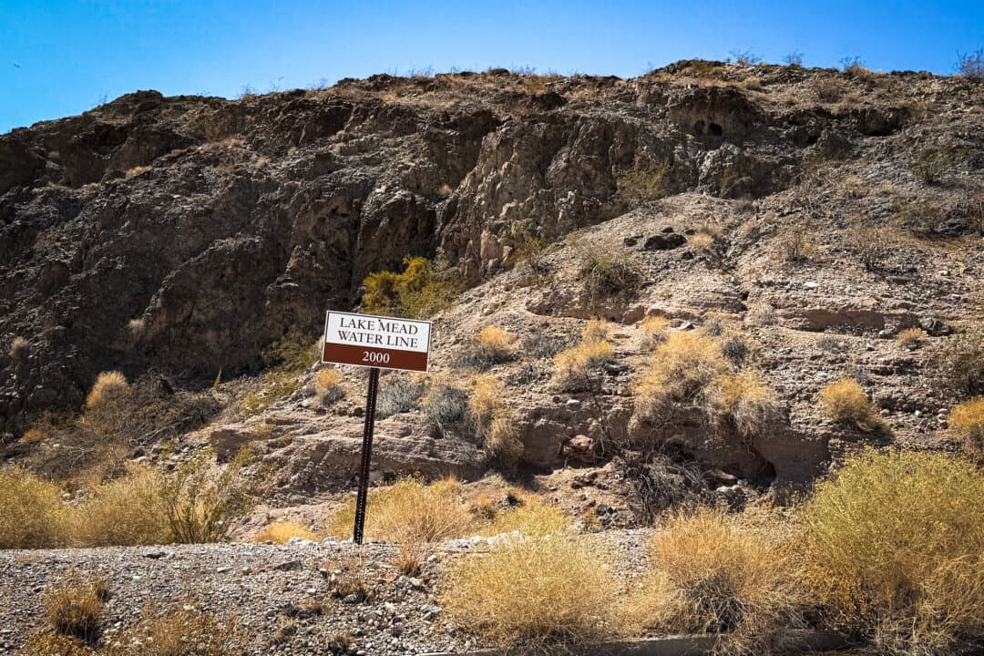 A sign marks the former water line at Callville Bay Marina on Lake Mead, near Boulder City, Nev., on Aug. 27, 2026. (Allan Stein/The Epoch Times)
