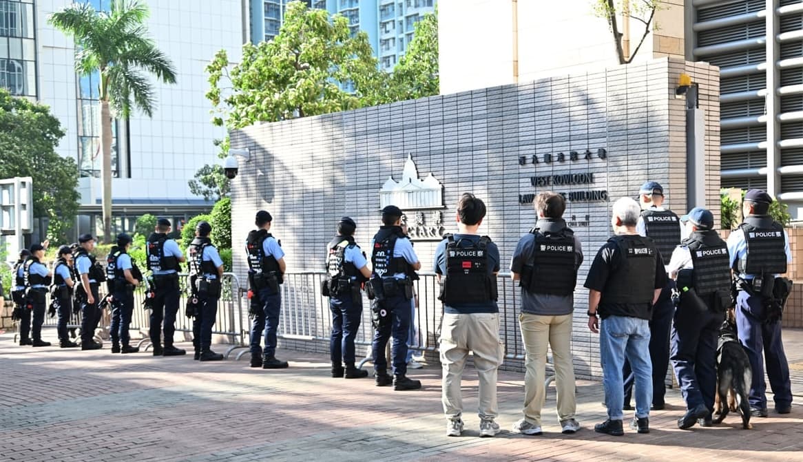 Police keep watch outside the West Kowloon Magistrates' Courts ahead of the national security trial of three pro-democracy activists who organized annual vigils to mark China's 1989 Tiananmen Square Massacre, in Hong Kong on Sept. 11, 2026. (Wu Ruilue/The Epoch Times)