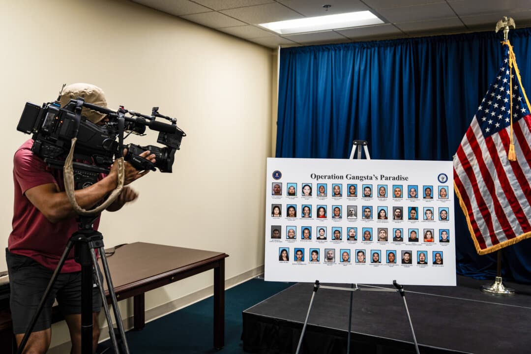 A cameraman records a board displaying individuals identified by law enforcement as alleged members and associates of the Mexican mafia, at a news conference in Santa Ana, Calif., on April 23, 2026. (Jae C. Hong/AP Photo)