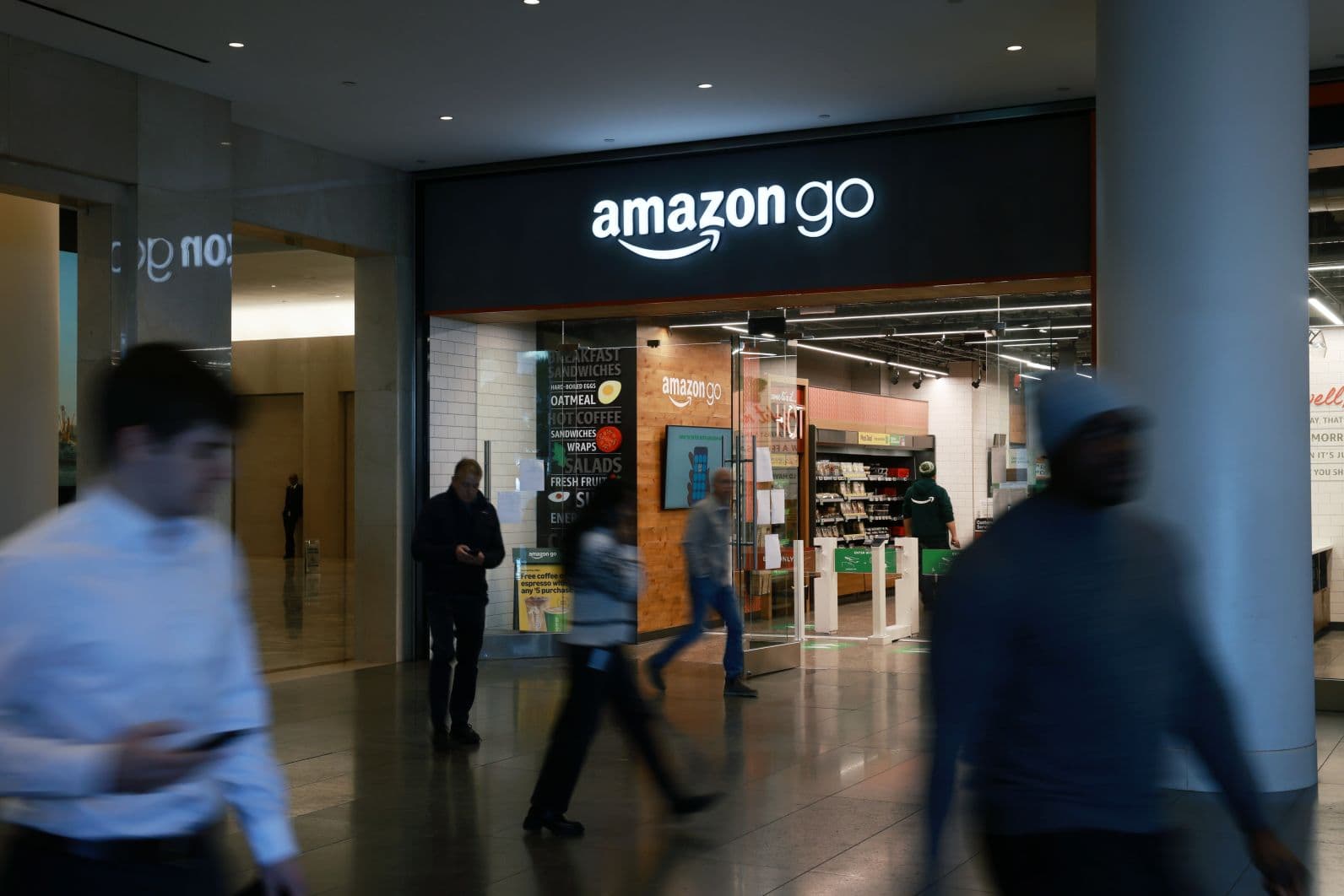 People walk past an Amazon Go store in a Manhattan mall in New York City. (Spencer Platt/Getty Images)