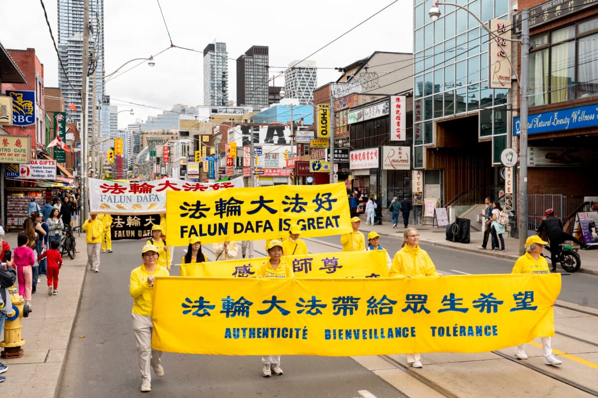 Falun Gong practitioners hold a parade in downtown Toronto to call for an end to the Chinese regime's persecution and transnational repression, on Sept. 19, 2026. (Evan Ning/The Epoch Times)