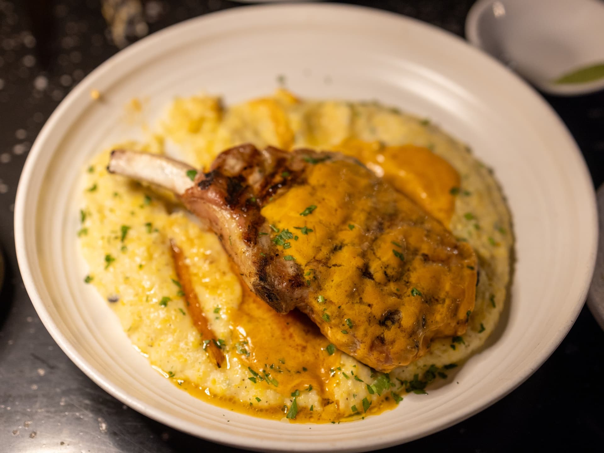 The bone-in pork chop at The Cork and Craft restaurant in San Diego. (Courtesy of Bryan Dahl)