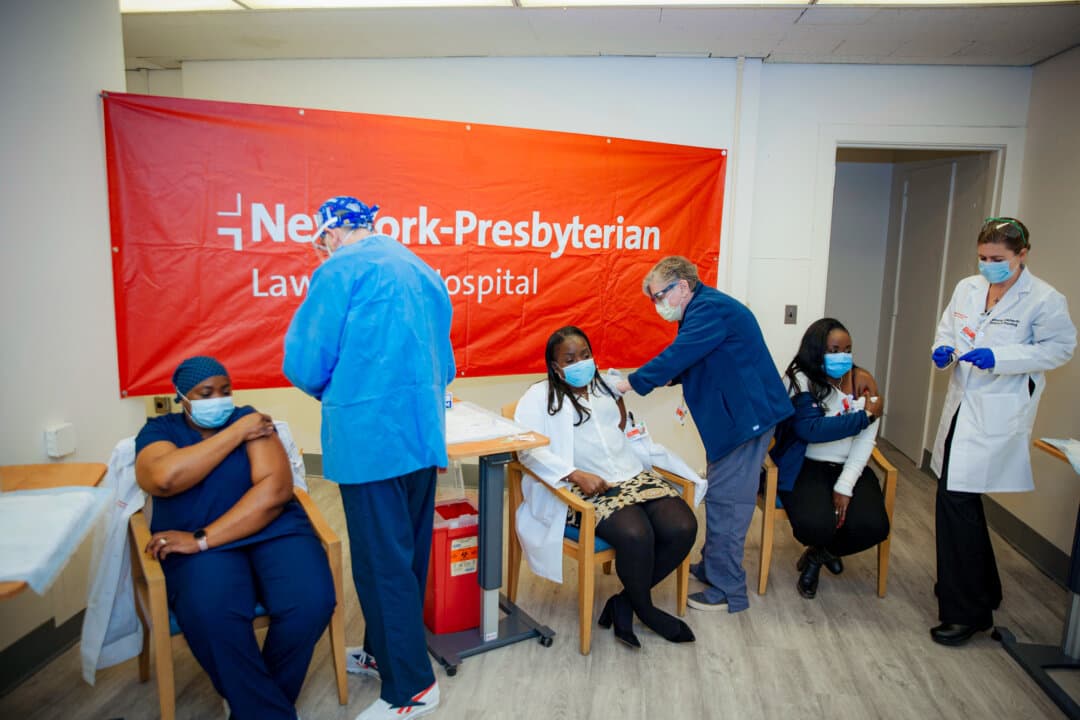 Doctors administer COVID-19 vaccine at NewYork-Presbyterian Lawrence Hospital in Bronxville, N.Y., on Jan. 8, 2021. Despite a recent uptick since the COVID-19 era, more than 4 in 10 doctors reported symptoms of burnout in 2025, according to the American Medical Association. (Kevin Hagen, File/AP Photo)