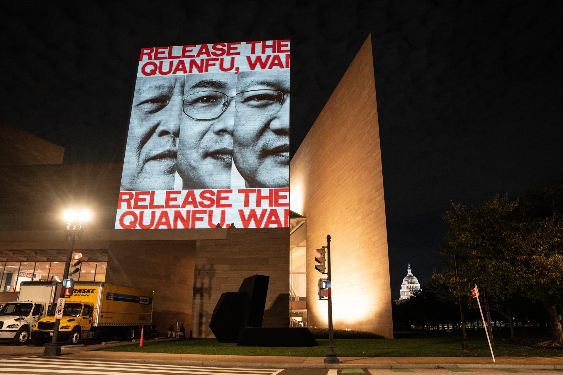 A projected photo of Wang Lin, Gao Yingjia, and Gao Quanfu, house church pastors imprisoned during the October 2025 clampdown on religious groups in China, is displayed on the National Gallery of Art, as Chinese leader Xi Jinping participates in a state visit to Washington on Sept. 23, 2026. (Samira Bouaou/The Epoch Times)