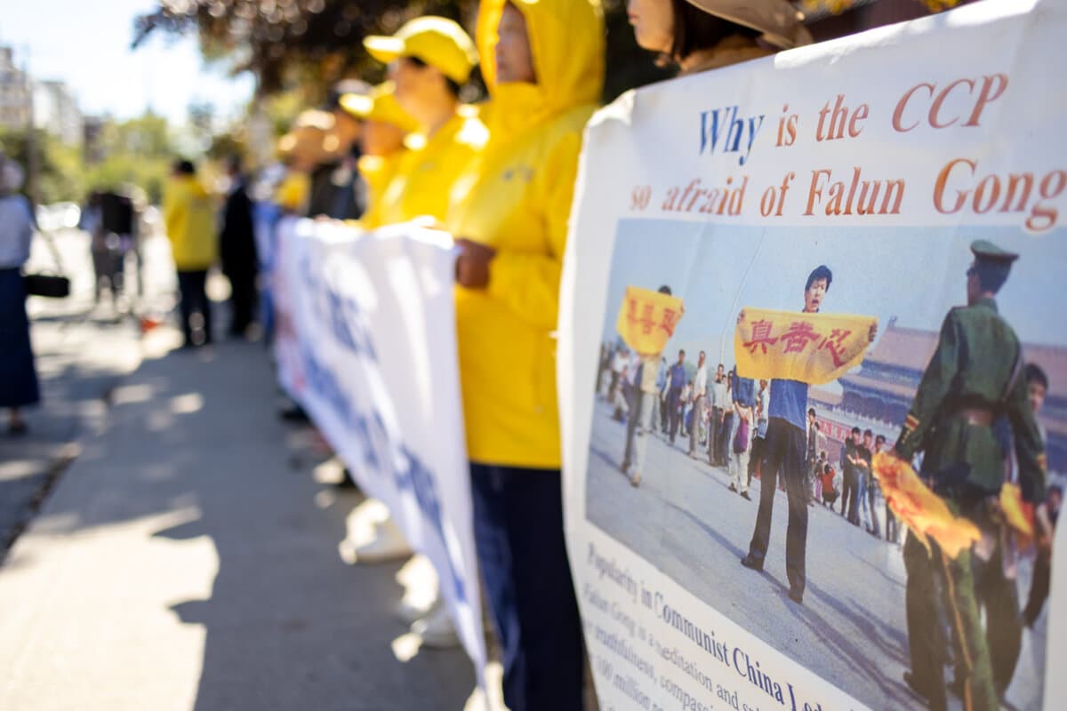 Falun Gong practitioners and supporters gather outside the Chinese Consulate in Toronto, after Falun Gong practitioners were attacked earlier in the week, on Sept. 24, 2026. (The Epoch Times)