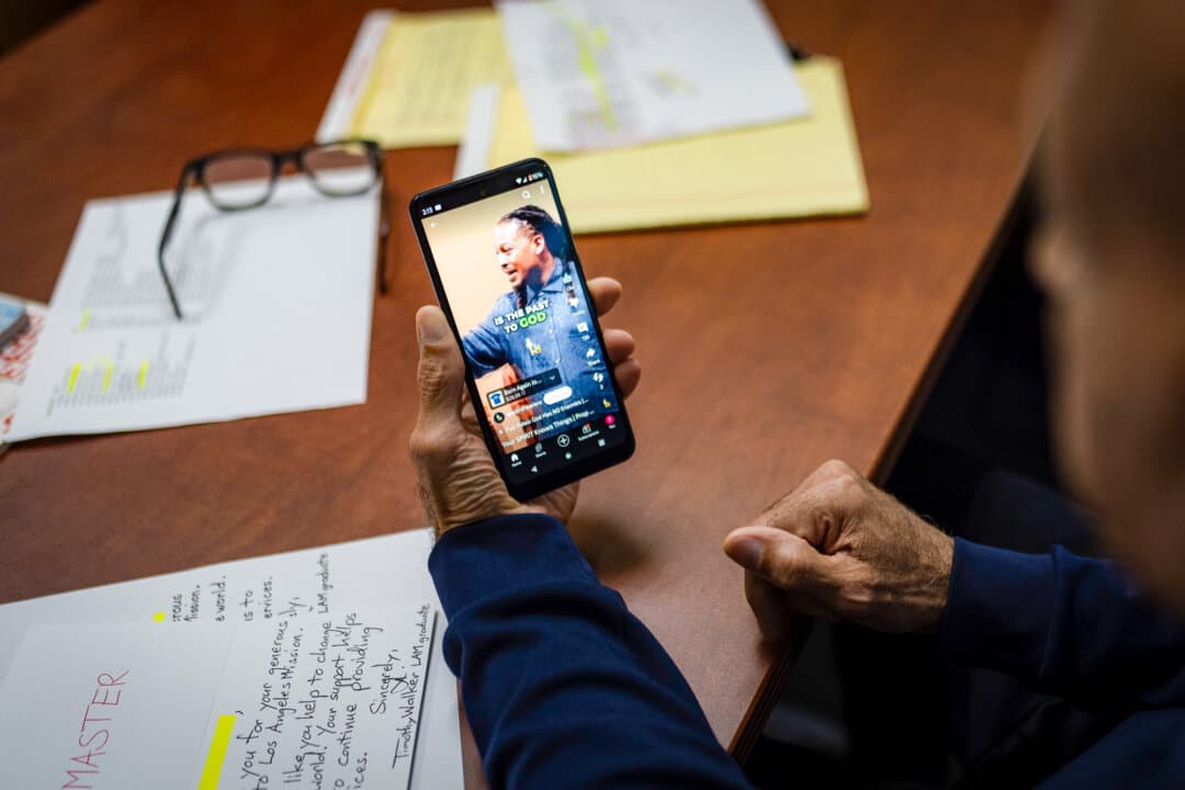 Timothy Walker, a resident at the Los Angeles Mission who graduated from its faith-based drug rehabilitation program, watches a Christian YouTube video in Los Angeles on Aug. 18, 2024. (Jae C. Hong/AP Photo)