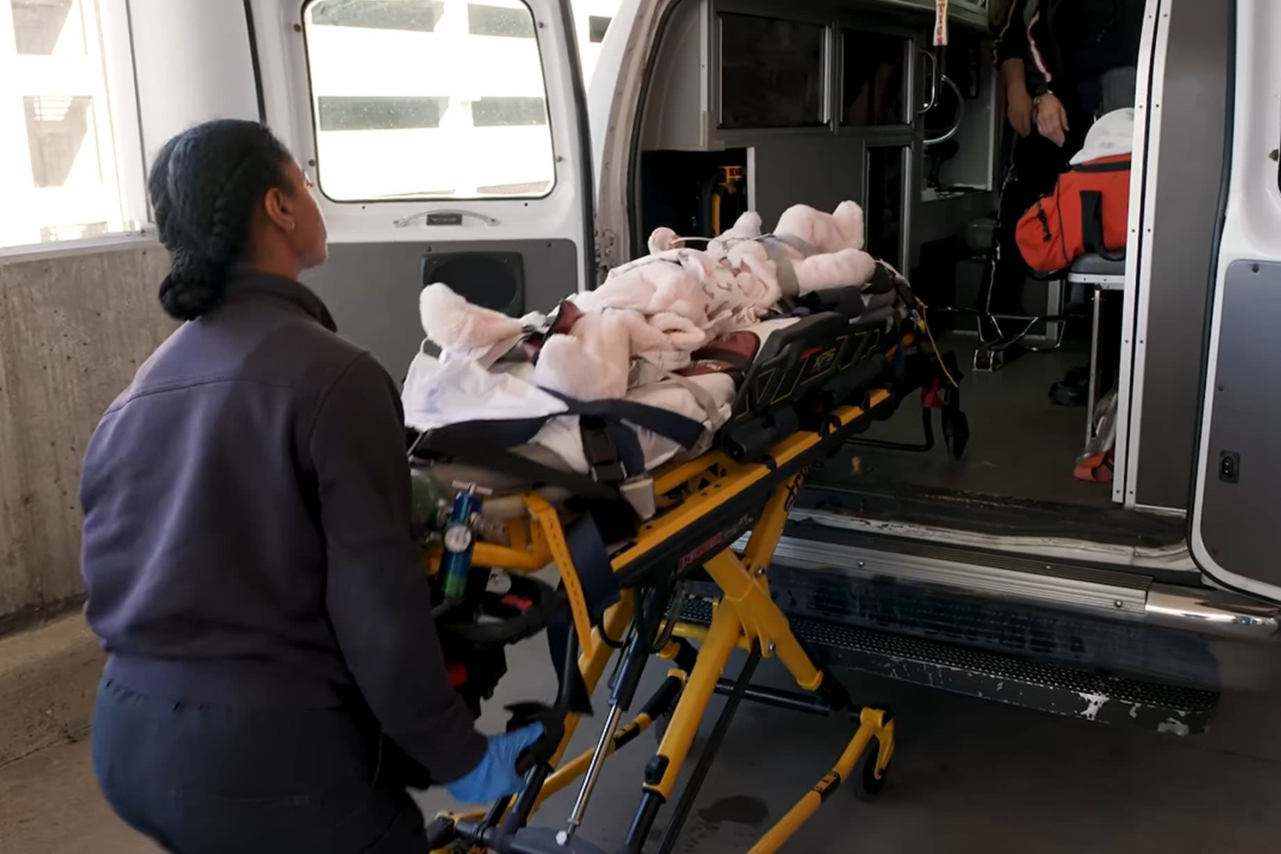 A transportation team takes the conjoined twins from a vehicle upon arrival in St. Louis in March 2025. (SSM Health Cardinal Glennon Children's Hospital)