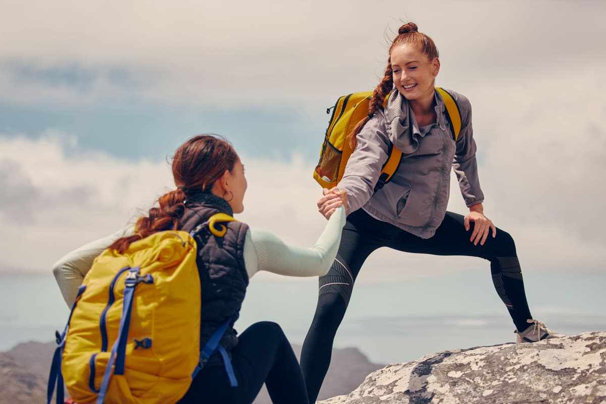 Walking up a hill with a friend makes it feel less steep. (PeopleImages/Shutterstock)
