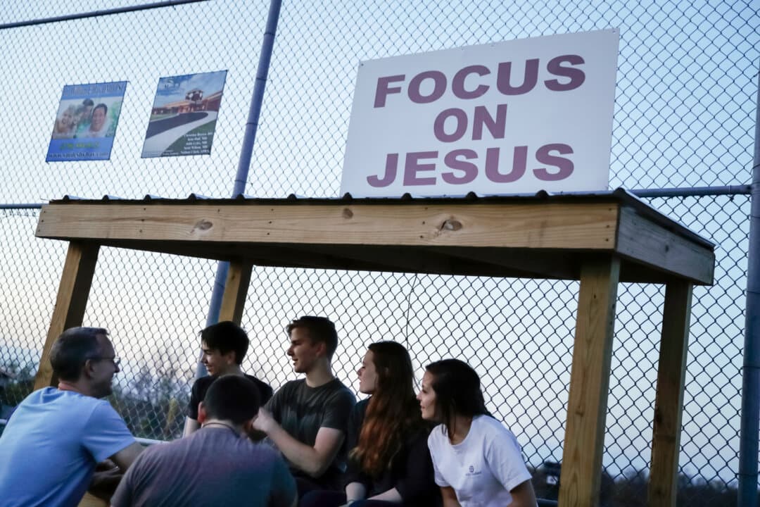 Young people gather on a baseball field at dusk outside the Christian Fellowship Church in Benton, Ky., on April 10, 2016. (David Goldman/AP Photo)