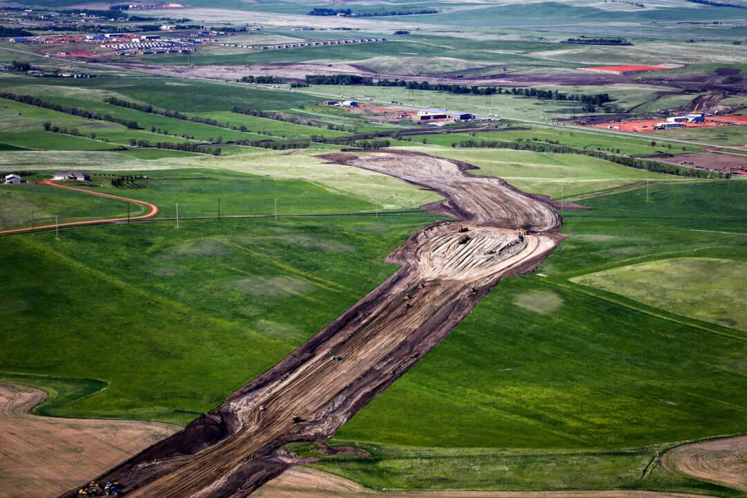 Heavy machinery plows through farmland during construction of the U.S. Route 85 bypass in Watford City, N.D., on June 12, 2014. The Supreme Court will also take up a case involving a family ranching enterprise whose land was seized as part of a natural gas development arrangement between a private company and the federal government, raising the issue of compensation under eminent domain. (Charles Rex Arbogast/AP Photo)