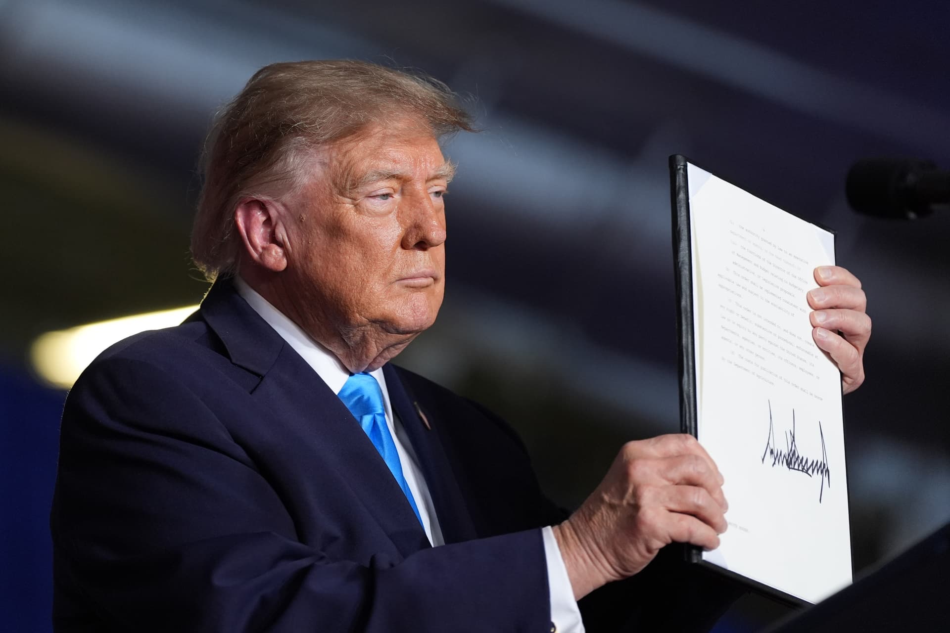 President Donald Trump displays a signed executive order at a campaign rally at the Pinnacle Bank Expo Center in Grand Island, Neb., on Oct. 5, 2026. (AP Photo/Alex Brandon)