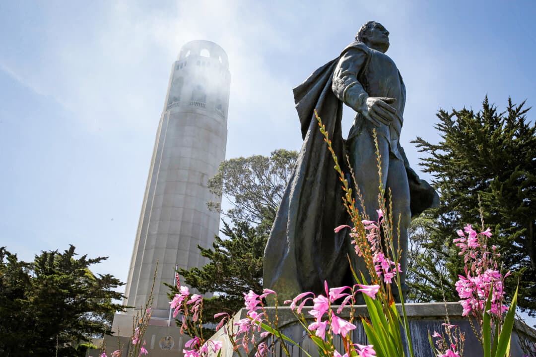 A statue of Christopher Columbus stands beneath Coit Tower in San Francisco on May 14, 2014. A few years later, the statue, like many others throughout the United States, would be vandalized: Red paint was poured over it and messages reading “Destroy all monuments of genocide” and “Kill all colonizers” were written on the concrete base. (AP Photo/File)