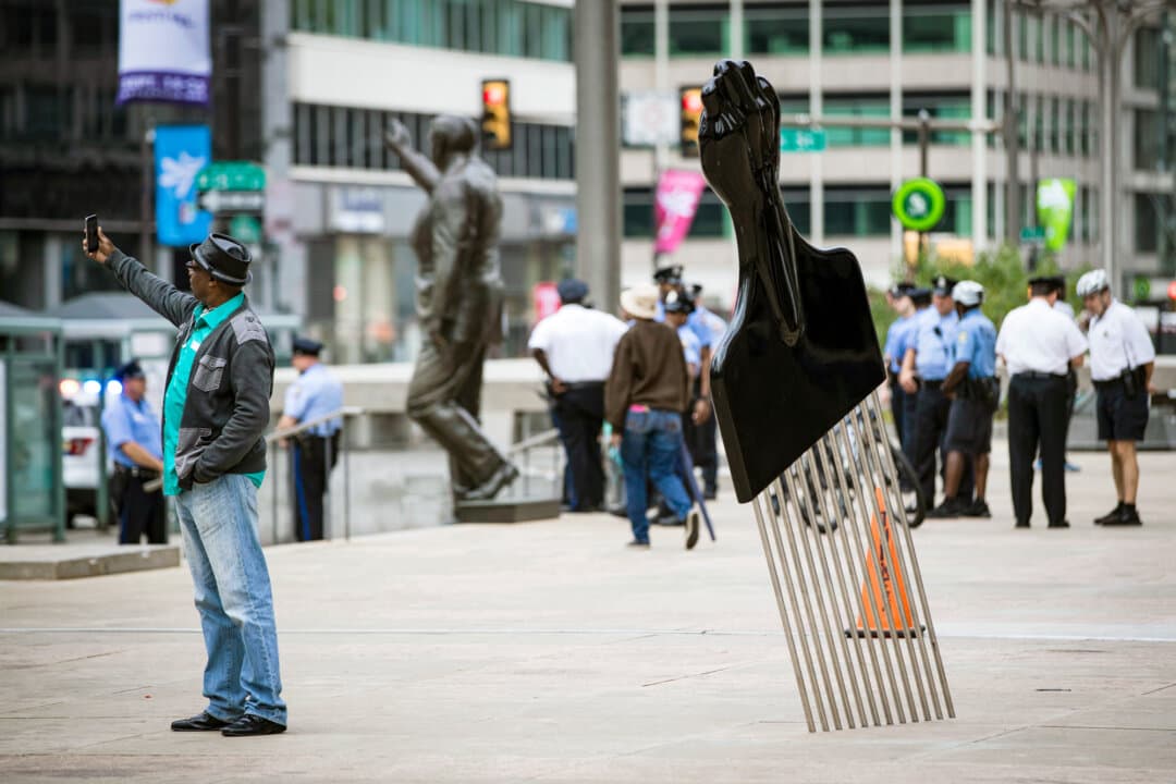 A man takes a selfie with Hank Willis Thomas's “All Power to All People” sculpture in Philadelphia on Sept. 14, 2017. The sculpture was part of an initiative by Monument Lab, a Philadelphia-based group that received a $4 million grant from the Andrew W. Mellon Foundation to “reimagine” the way history is told in public spaces. (Matt Rourke/AP Photo/File)
