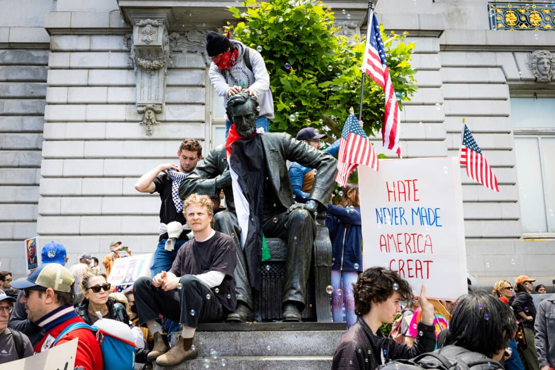 (Clockwise from Top Left) Protesters surround the Robert E. Lee statue in Richmond, Va., on June 23, 2020. A demonstrator hangs a banner from a statue of Union Army Gen. Harrison Gray Otis in MacArthur Park in Los Angeles during a May Day demonstration on May 1, 2026. Protesters climb on a statue of Abraham Lincoln during a “No Kings” protest in San Francisco on June 14, 2025. Protesters gather around a vandalized statue of Ponce de Leon in downtown Miami on June 12, 2020. A wave of backlash against figures like Christopher Columbus, Juan Ponce de León, and famous U.S. presidents portrays them as symbols of oppression or white privilege. (Eze Amos/Getty Images, Justin Sullivan/Getty Images, Benjamin Fanjoy/AP Photo, Chandan Khanna/AFP via Getty Images)